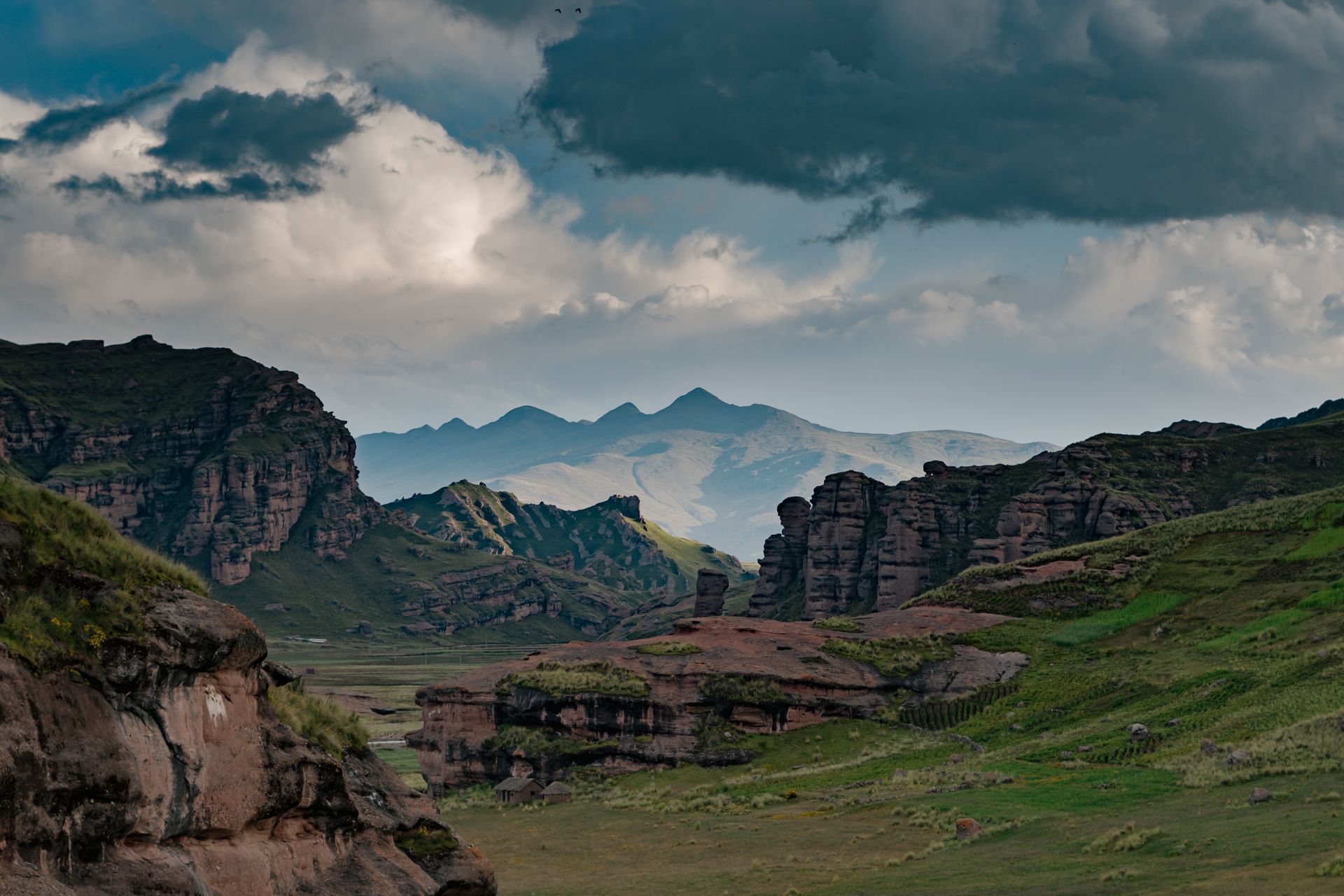 A dramatic mountain landscape beneath gathering clouds